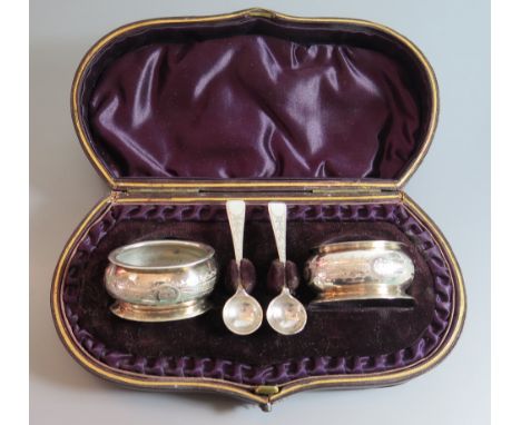 A Pair of Victorian Silver Salts and spoons with chased stylised foliate decoration and in original case (no liners), Birming