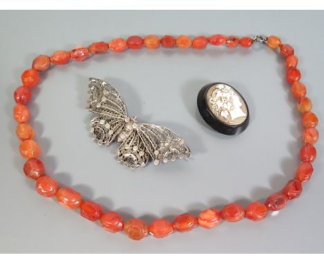 A Victorian Cameo Brooch  Mounted on Jet, silver filigree butterfly brooch and carved agate bead necklace 