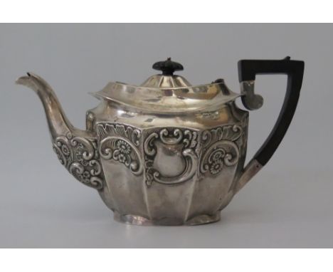 An Edward VII Silver Teapot of decagonal shape and embossed foliate scroll decoration, with marriage inscription, Birmingham 