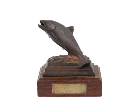 A Fly Fishing competition trophy. Featuring a David Hughes sculpture of a fish on a wooden stand, the brass plaque reading 'V