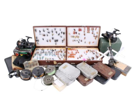 An assortment of fishing equipment. Including a boxed Daiwa Carbonline SS-900RDA, two cases of fishing flies, a 375 Dragonfly