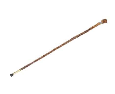A novelty walking stick. The wooden handle carved as a bulldog's head, with enamel eyes and wearing a brown leather collar wi