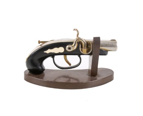 A novelty desk lighter modelled as a pistol. Worked by pulling the trigger, mounted on a shaped brown bakelite stand, L15cm