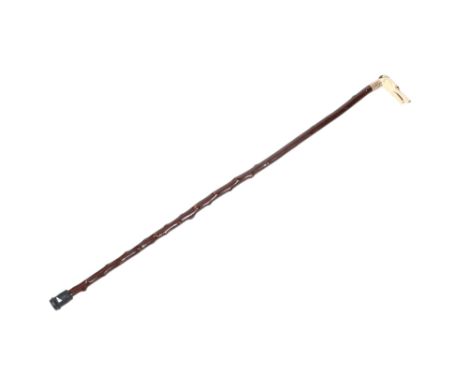 An early 20th century novelty walking stick. The ivory handle carved as a greyhound's head, with glass eyes, having a 9ct gol
