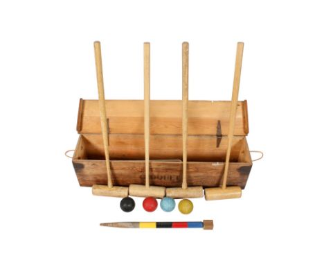 A vintage lawn croquet set in a pine box. Including four mallets, four balls, etc. H27cm x W110cm x D24cm