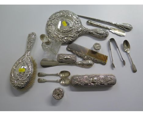 A lady's toilet collection consisting of a silver hand mirror, brush and comb, silver topped glass jars, shoe horn, etc 