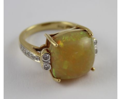 An 18ct yellow gold ladies' dress ring set with a cabochon Ethiopian jelly opal, size M, approx 8.2g. CONDITION REPORT No Cer