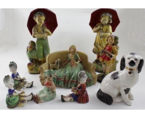 Nine c1930s plaster and ceramic figures to include a Staffordshire dog, a pair of figures depicting boy and girl fruit seller