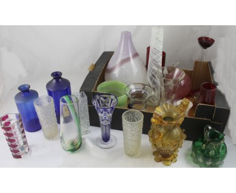 A quantity of studio glass including vases of various forms, candle holders and two vintage blue glass chemists' bottles.