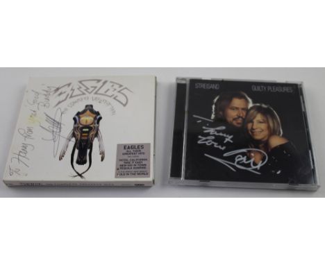 A signed Streisand 'Guilty Pleasures CD and a signed 'Eagles: The Complete Greatest Hits' CD (2).