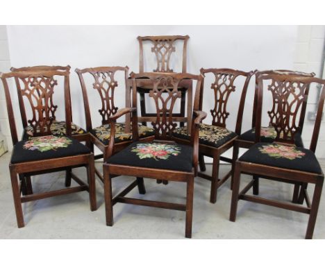A set of eight 18th century Chippendale style dining chairs to include one carver, each with various floral tapestry seats (8