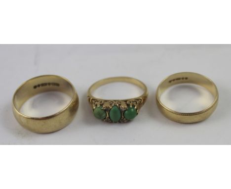 Two 9ct gold wedding bands, sizes P and Q1/2 and a 9ct gold three-stone jade dress ring, size L1/2, combined approx 10.5g.