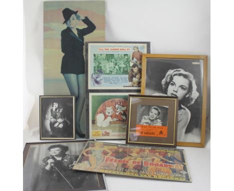 A selection of Judy Garland and other movie posters including a portrait of Judy Garland, a 7" single cover of 'If You Feel L