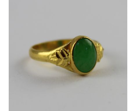 A 24ct gold jade cabochon ring, marked 9999 to the shank, size L, approx 3g. CONDITION REPORT slightly misshapen otherwise no