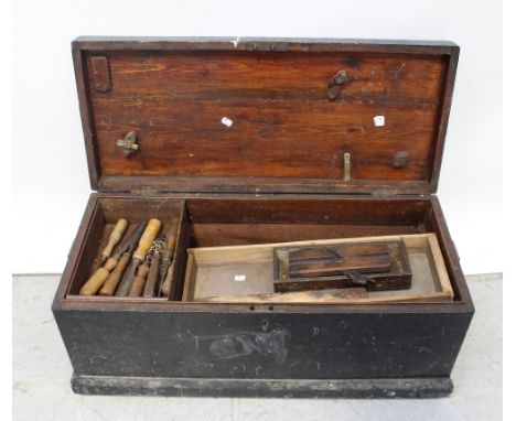 A vintage toolbox with various vintage tools to include chisels, planes, saws etc.