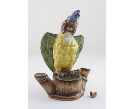 A 19th century decorative Majolica bowl in the form of a tree trunk with a large parrot to the branch, partial paper label to