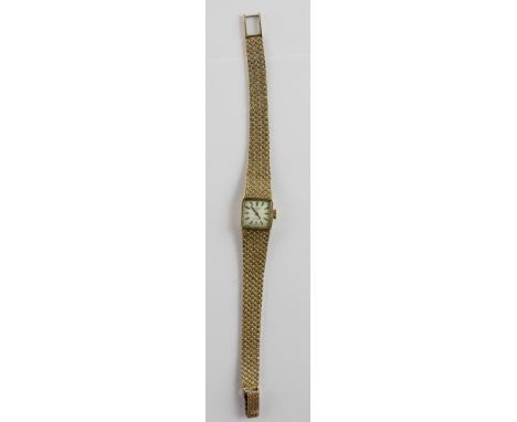 Rotary; a 9ct gold ladies wristwatch with square baton dial, on textured 9ct gold strap, approx 29.5g.