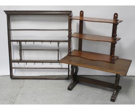 An early 20th century oak wall-hanging rack for cups and plates, a 20th century mahogany three-tier wall-hanging whatnot, 51 