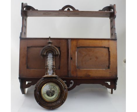 A late Victorian red walnut wall-mounted shelf rack and cabinet, width 59.5cm and a stained beech aneroid barometer (2).