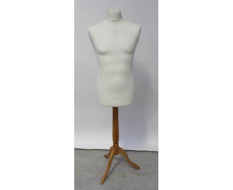 A mid-20th century male mannequin on tripartite base support.