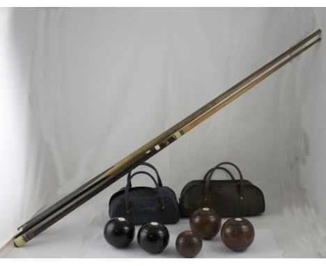A set of vintage lignum vitae Crown Green bowling woods, two Greenmaster bowls and three snooker cues (5). CONDITION REPORT R
