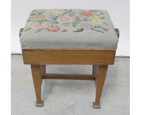 An Edwardian piano stool, tapering supports and cross-stretcher with floral tapestry seat.