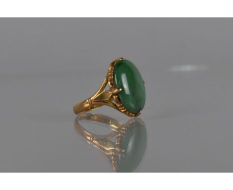 An Eastern 22ct Gold and Jade Cabochon Ring, Shallow Oval Cabochon Measuring 16mm by 11mm in a Four Claw Setting Mounted on a