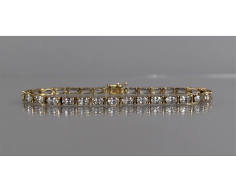 A 9ct Gold and White Sapphire Tennis Bracelet, 30 Oval Cut Sapphires Measuring 5mm by 3mm, in a Four Claw Setting, 10.4gms, S