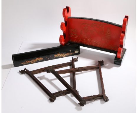 Two Chinese hardwood folding wall brackets, with carved dragon head and scroll decoration, 36.5cm wide, red and black painted