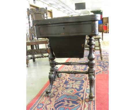 A VICTORIAN GRAINED ROSEWOOD AND INLAID SERPENTINE WORK TABLE, THE FOLD OVER TOP INLAID FOR DRAUGHTS, CRIBBAGE AND BACKGAMMON