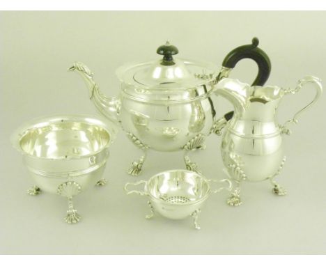 AN EDWARD VII/GEORGE V SILVER THREE PIECE TEA SERVICE ON SHELL FEET, LONDON 1908, 1912 AND 1913 AND A SILVER TWO HANDLED TEA 