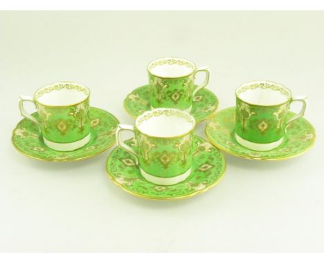 A SET OF FOUR ROYAL CROWN DERBY APPLE GREEN GROUND COFFEE CANS AND SAUCERS, ONE COFFEE CAN CRACKED 