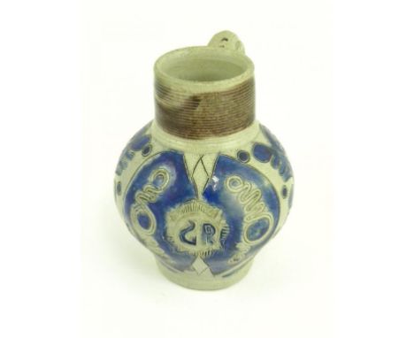 A GERMAN SALTGLAZED GREY STONEWARE JUG, WITH MOULDED DECORATION INCORPORATING THE ROYAL CYPHER G R, GLAZED IN COBALT AND MANG