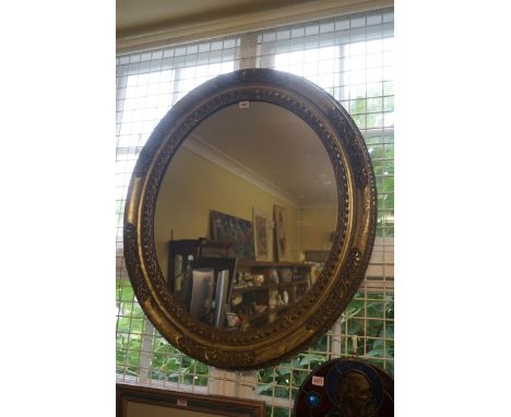 A late 19th century gilt framed oval wall mirror,&nbsp;94 x 84cm. 