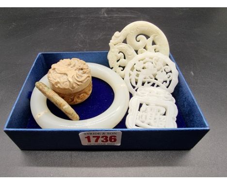 Four Chinese carved jade pendants; together with a pale celadon jade bangle, (cracks); and small soapstone box and cover. (6)