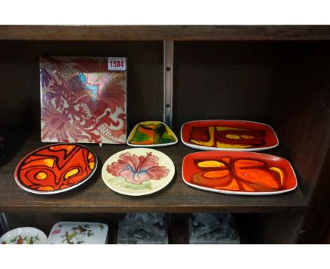 A William de Morgan style lustre tile,&nbsp;15.5cm square; together with five small Poole dishes; and a similar Moorcroft exa
