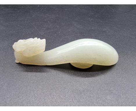 A Chinese carved pale celadon jade dragon buckle,&nbsp;7.4cm long.&nbsp; 