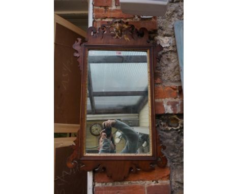 An antique walnut and parcel gilt fret frame wall mirror,&nbsp;79 x 45.5cm.&nbsp; 
