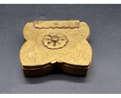 A vintage Line Vautrin gilt brass compact, of shaped outline, the hinged cover decorated with stylized foliage, 6.7cm wide. 