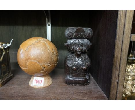 A carved wood globe, 11.5cm diameter, on wood stand; together with a small antique carved oak caryatid, 17.5cm high.&nbsp; 