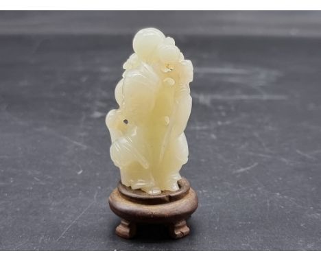 A Chinese carved pale celadon jade figure group,&nbsp;depicting a man with a child on his shoulder and a bird at his feet, 5.