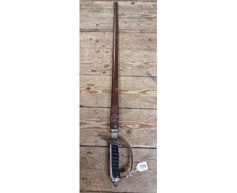 An early 20th century 1897 pattern Royal Army Ordnance Corps Officer's sword and leather scabbard, having etched 81cm blade b