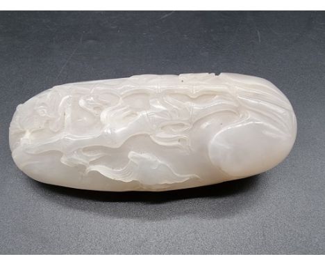 A Chinese carved white jade pebble, 11cm wide.&nbsp; 