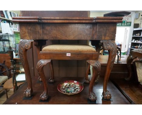 A 18th century figured walnut card table,&nbsp;with outset corners, on cabriole legs with ball and claw feet, 85cm wide, (the