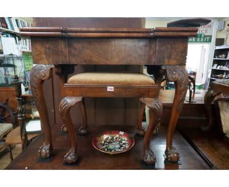 A 18th century figured walnut card table,&nbsp;with outset corners, on cabriole legs with ball and claw feet, 85cm wide, (the