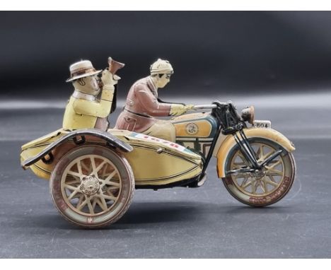 A vintage tinplate clockwork motorcycle and sidecar figure group,&nbsp;17cm long. 