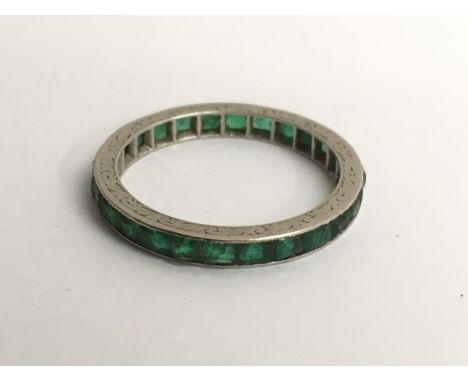 A white gold and emerald eternity ring, approx L/M