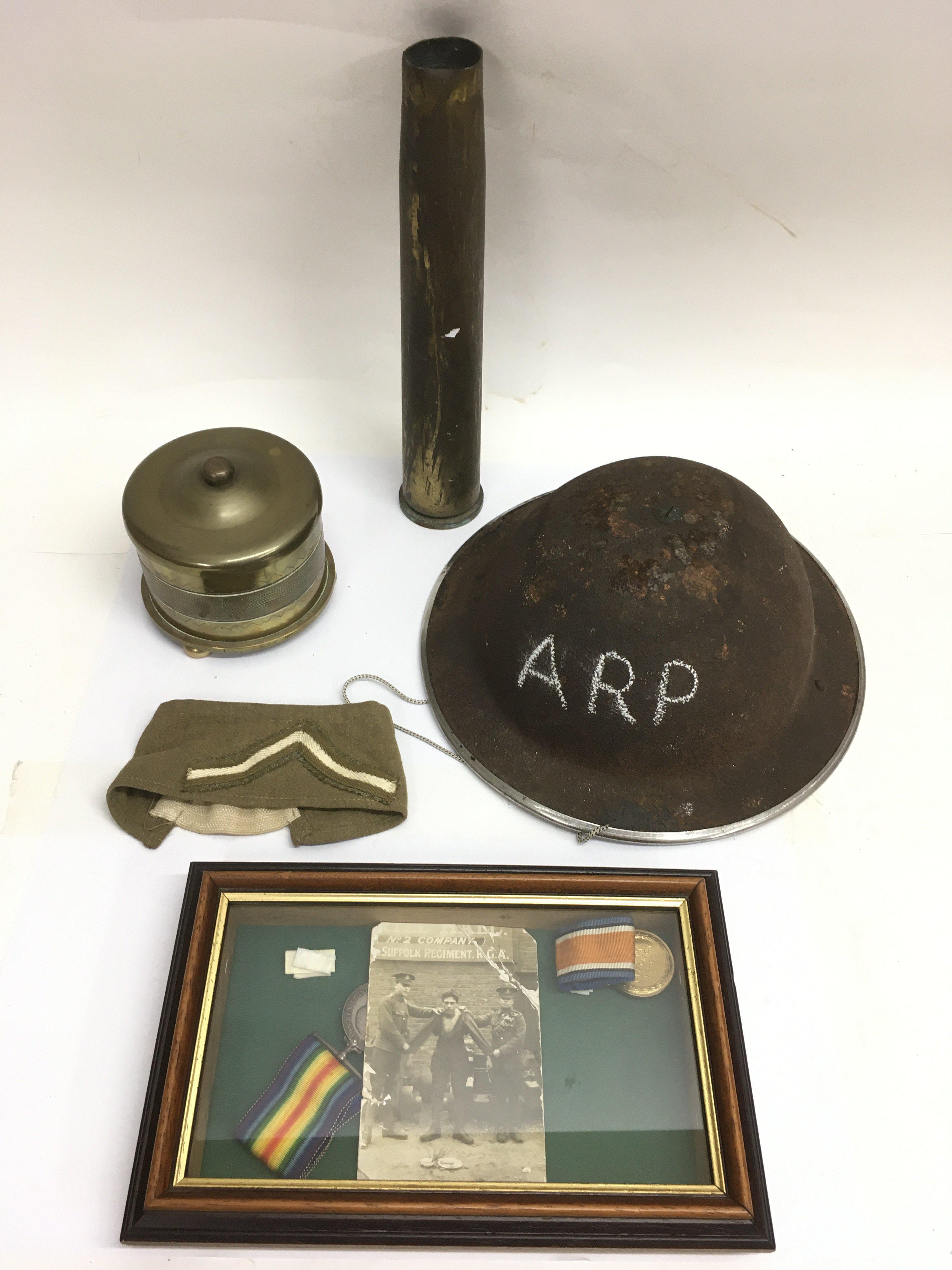 A group of military items including cased WW1 medals and trench art