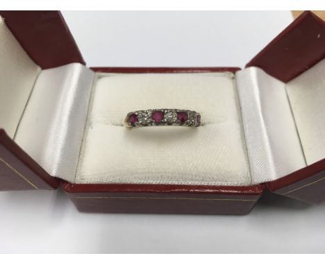 An unmarked gold ruby and diamond ring.