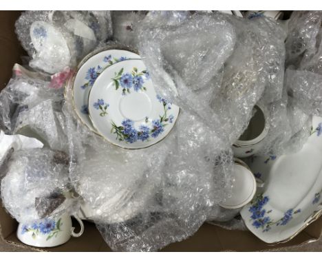 A box of vintage tea and dinner china